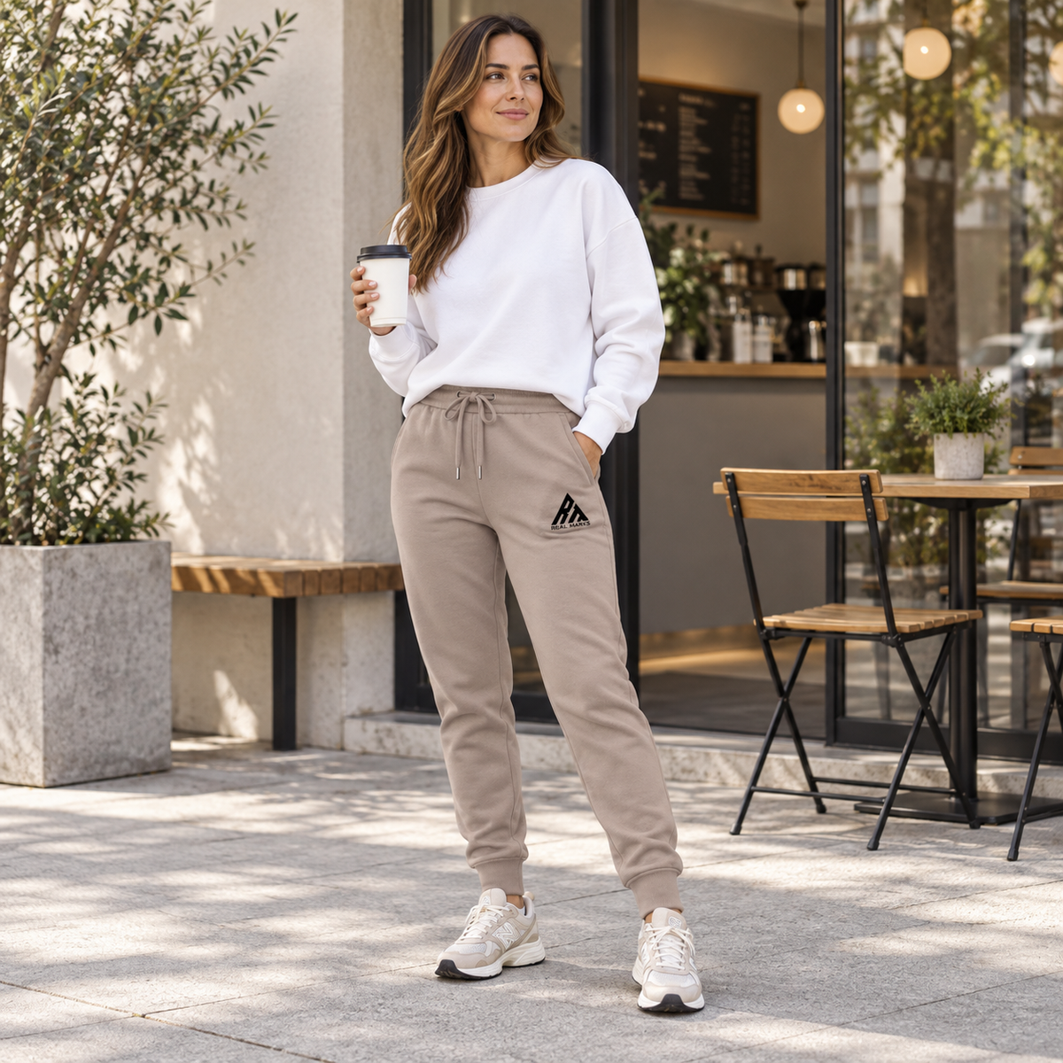 Woman wearing Real Marks tapered everyday joggers in taupe