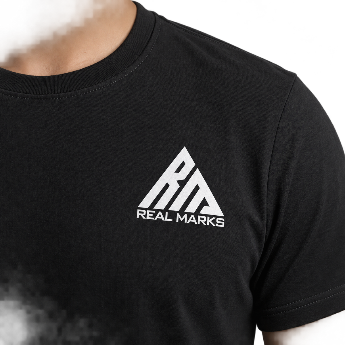 Close-up of full Real Marks chest logo on T-shirt