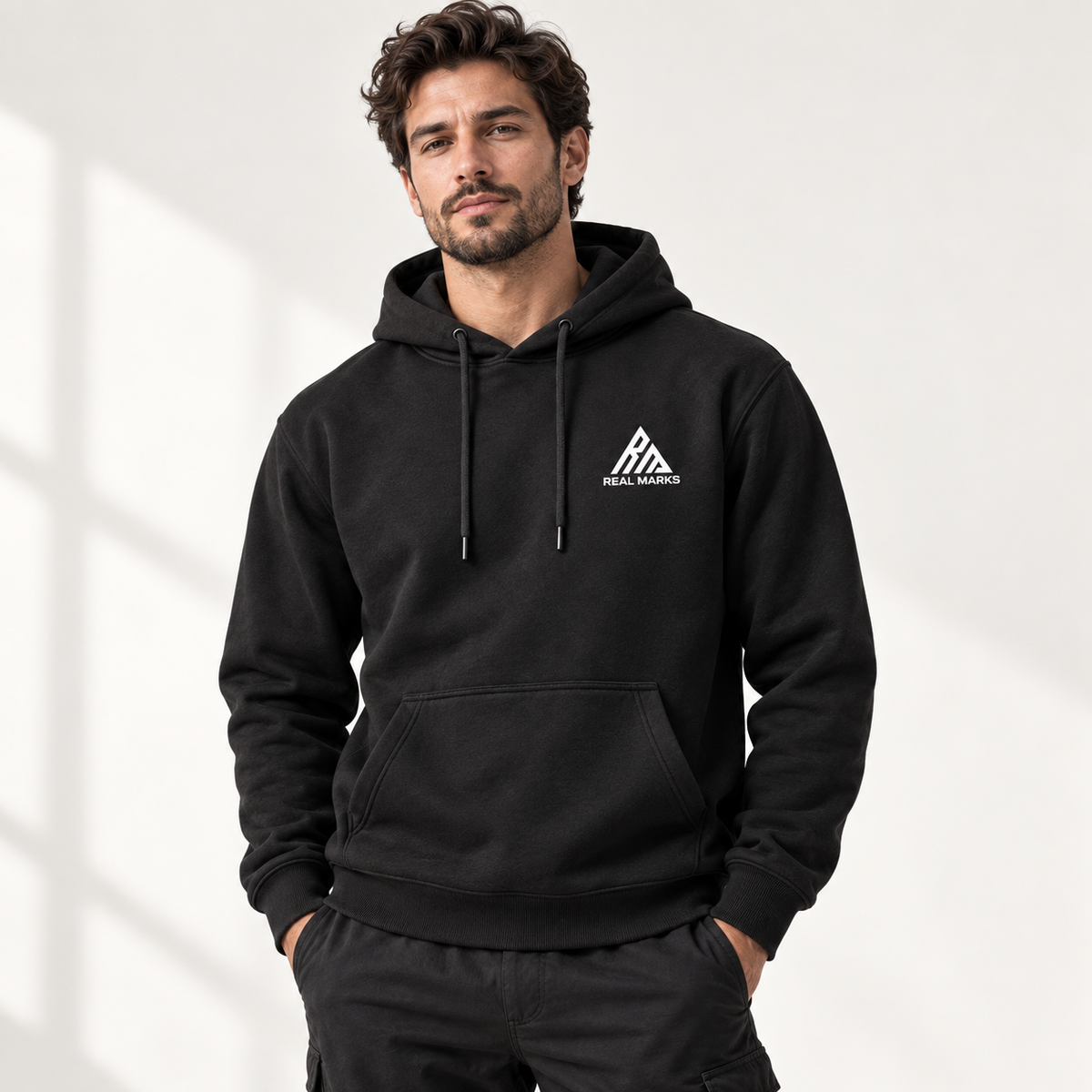 Male model wearing the black Real Marks Everyday Pullover Hoodie