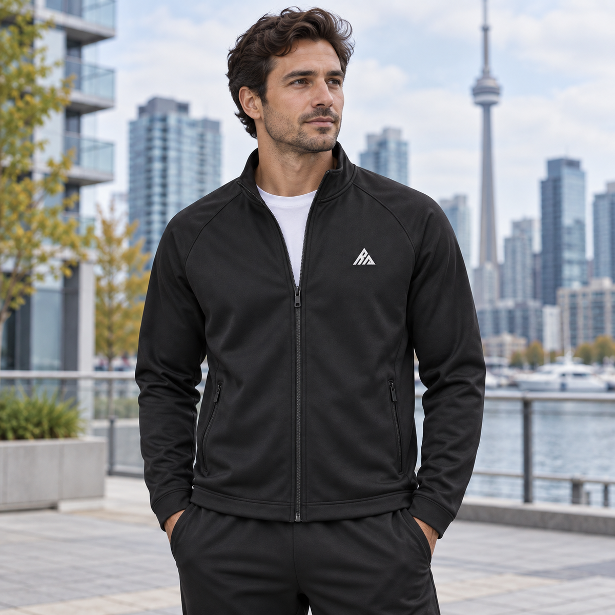 Man wearing the Real Marks minimal track jacket in black outdoors