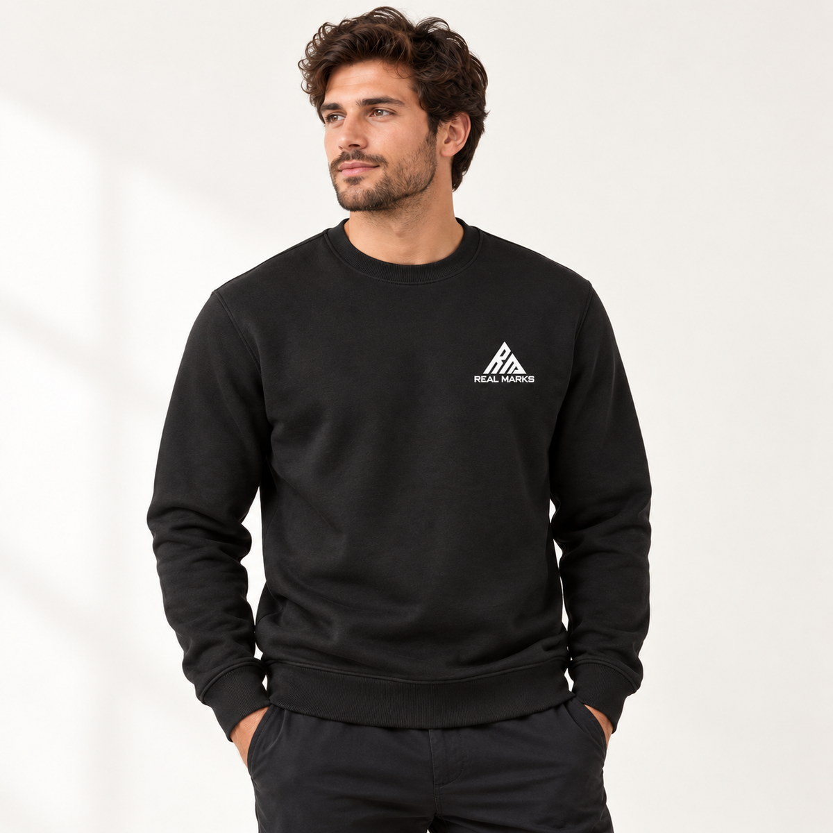 Male model wearing the black Real Marks Signature Crewneck Sweatshirt