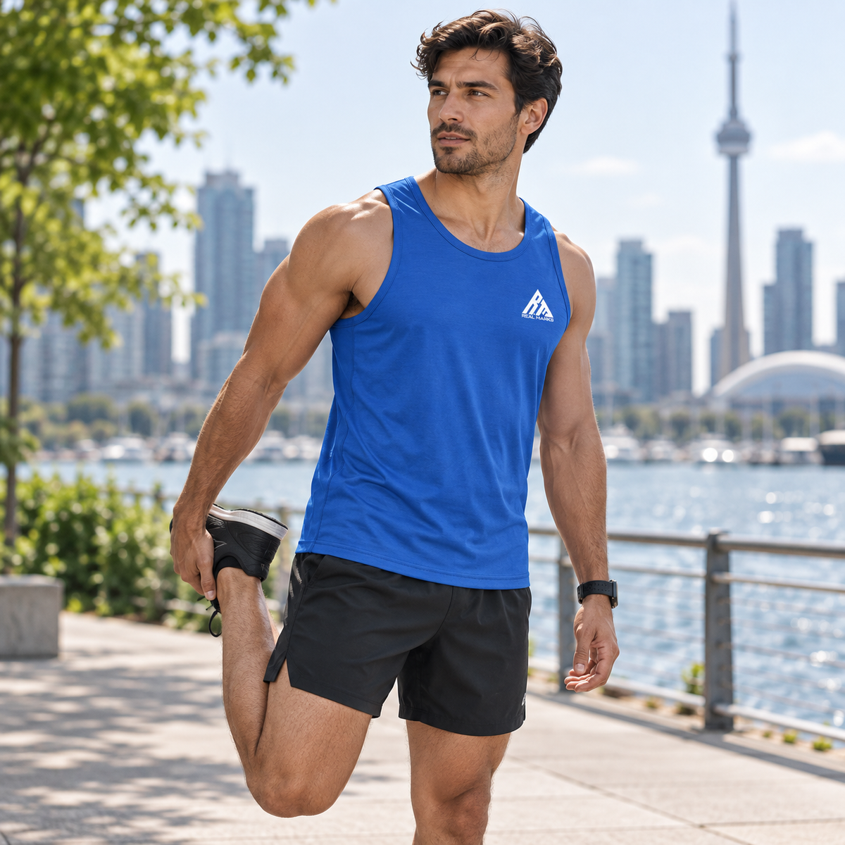 Man warming up outdoors wearing the royal blue Real Marks training tank