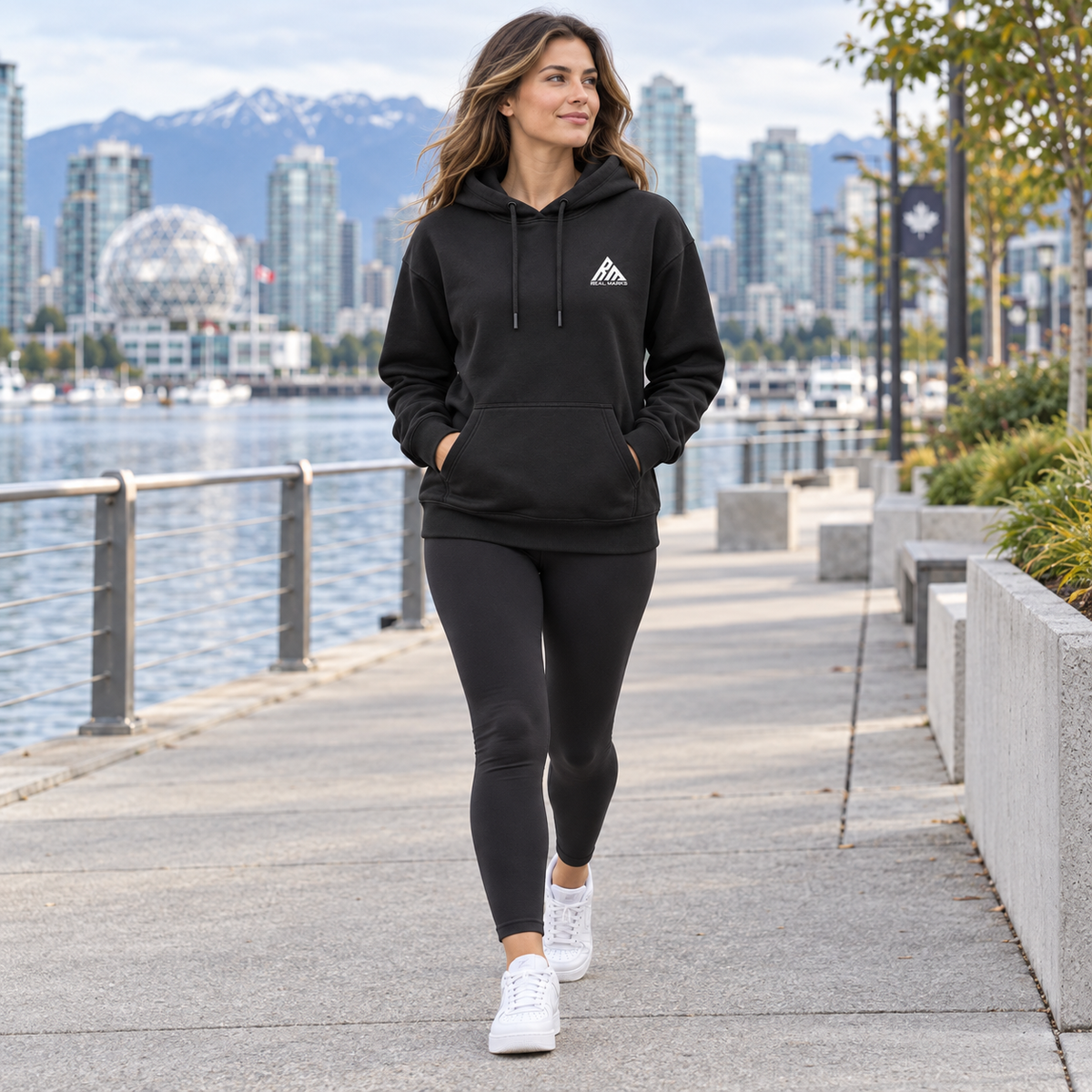 Woman wearing the black Real Marks everyday pullover hoodie outdoors