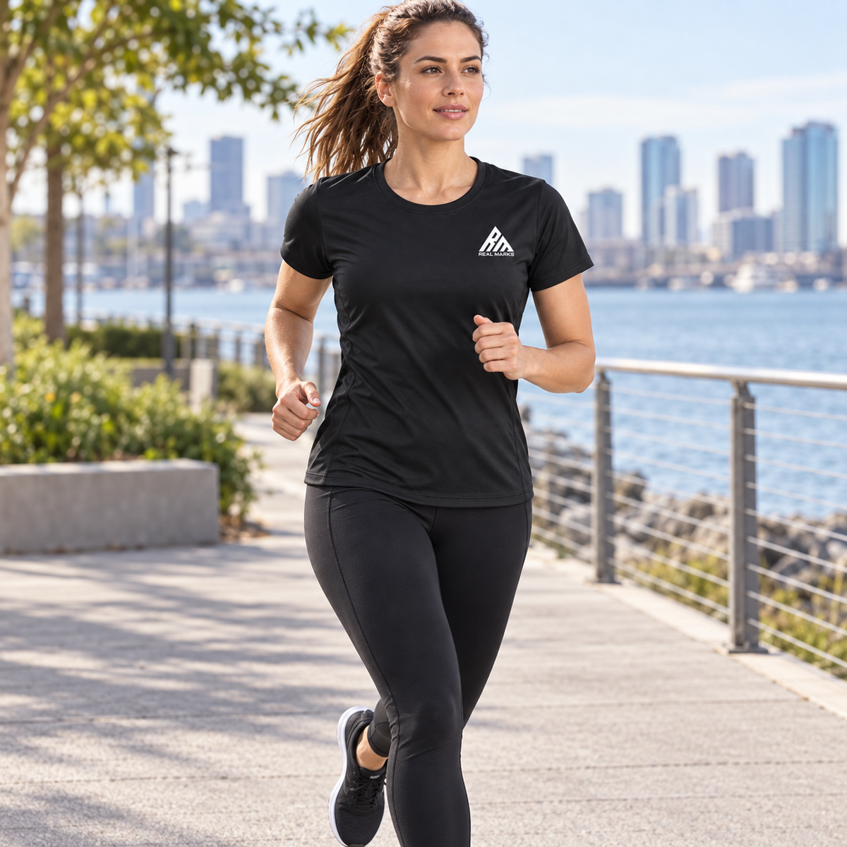 Woman running outdoors in the black Real Marks performance training T-shirt